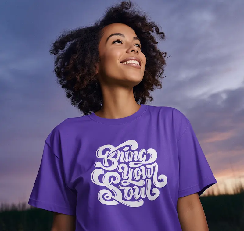 A woman wearing a purple Bring Your Soul shirt