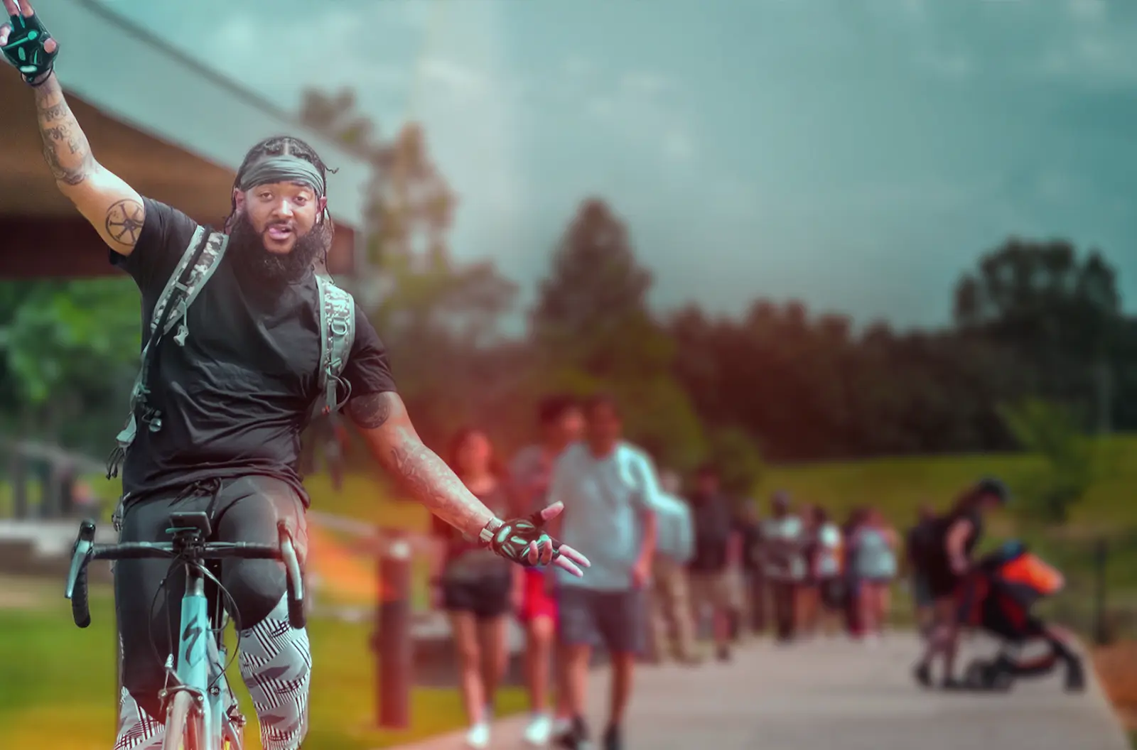 A man riding his bicycle with no hands on the handlebars