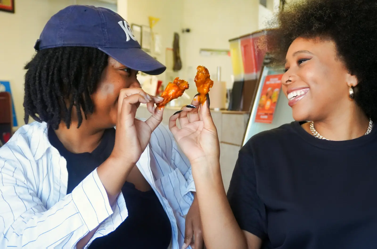 Two women about to eat hotwings