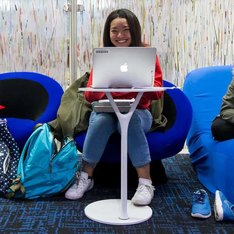 A young intern working at a laptop