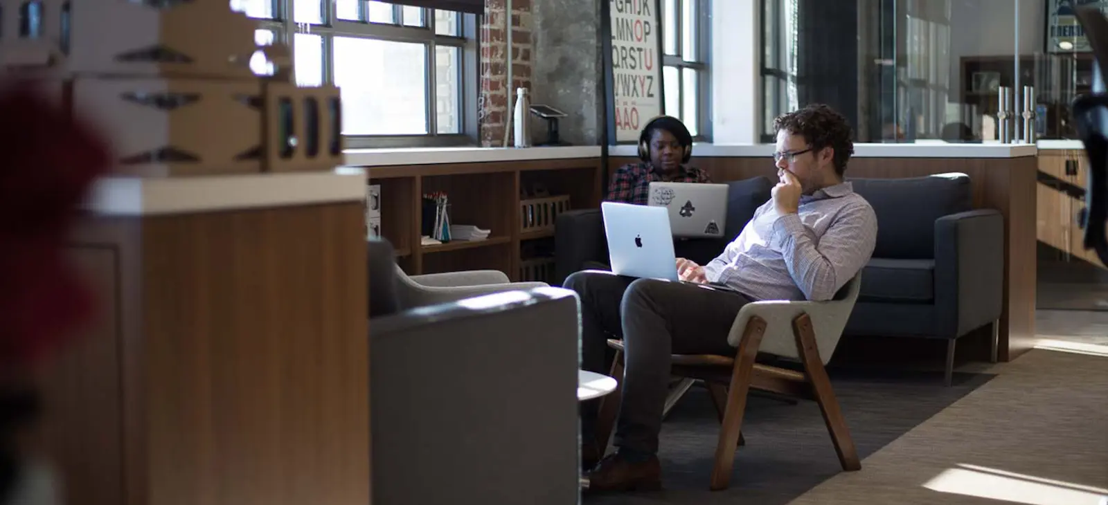 Two people working on their laptops