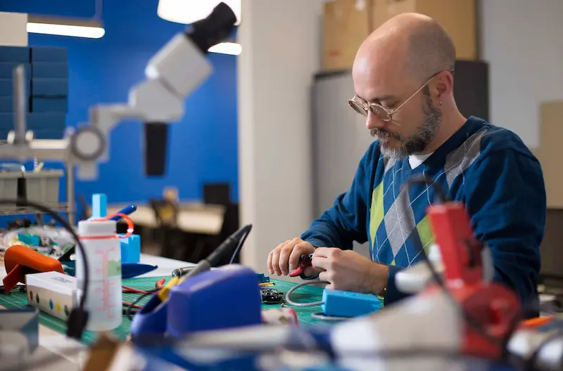 Middle aged man working on electronic circuitry