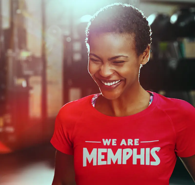 A woman wearing a red We Are Memphis t-shirt